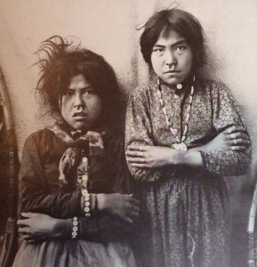 Two Tlingit girls, Tsacotna and Natsanitna, pose for a photograph in 1903. The nose rings are common ornaments among Indians of the Northwestern tribes, jewelry being a symbol of status.